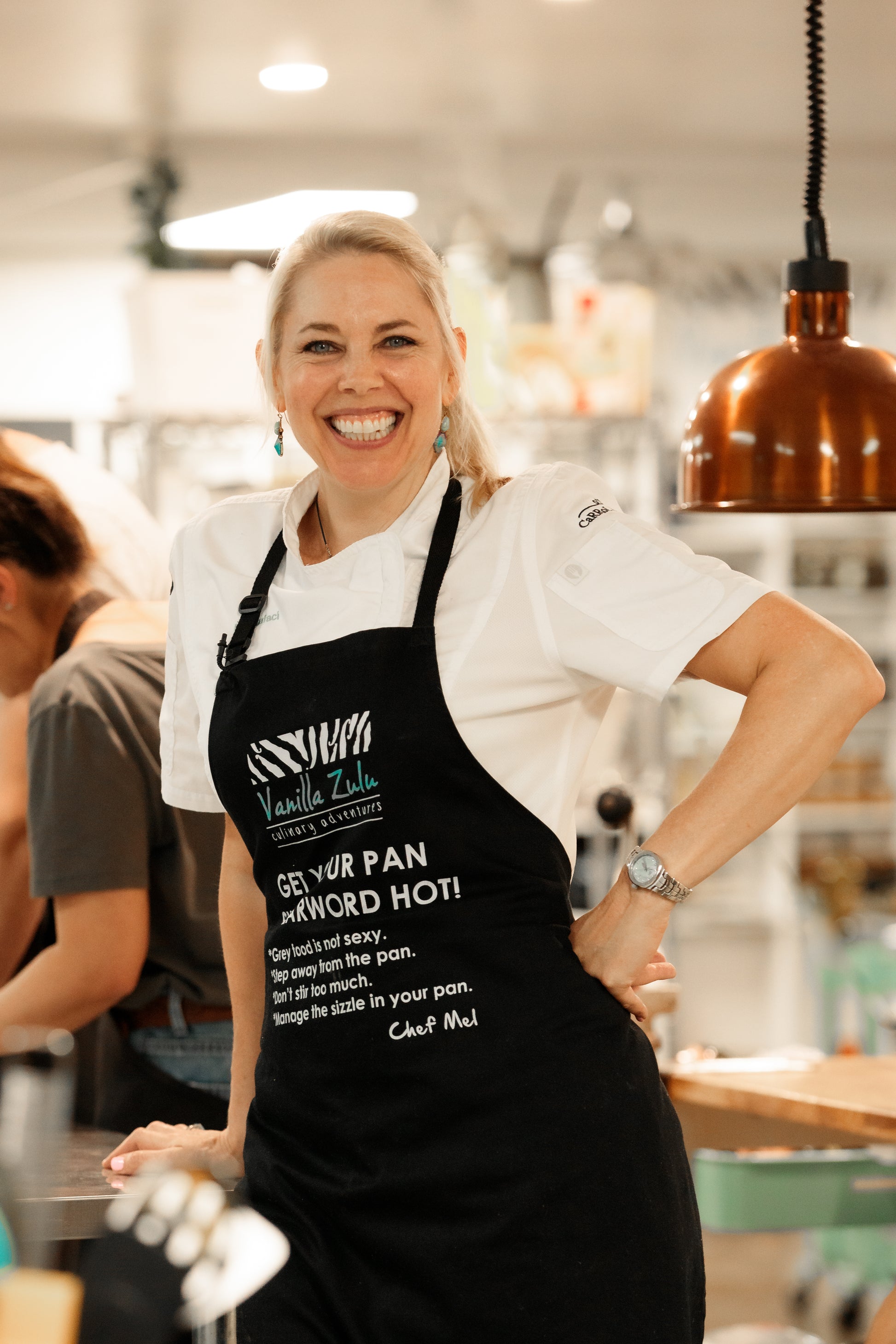 Chef Mel Cooking in apron cooking coach
