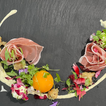 Quail egg confit with prosciutto rose and truffled creme